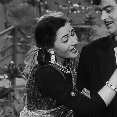 A Black And White Photo Of A Man And A Woman Smiling GIF