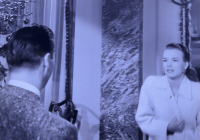 A Black And White Photo Of A Man And Woman GIF