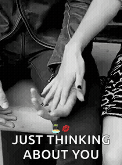 A Black And White Photo Of A Man And Woman Holding Hands With The Words `` Just Thinking About You '' . GIF