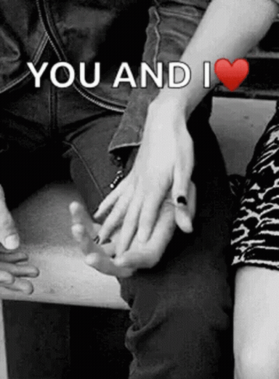 A Black And White Photo Of A Man And Woman Holding Hands With The Words `` You And I '' Written Above Them . GIF