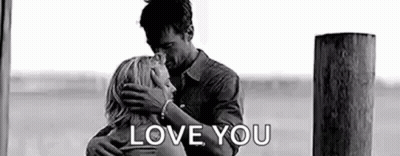 A Black And White Photo Of A Man And Woman Hugging Each Other And The Words `` Love You '' . GIF