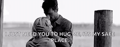 A Black And White Photo Of A Man And Woman Hugging Each Other . GIF
