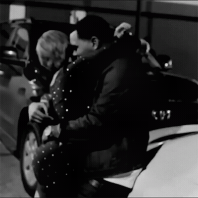 A Black And White Photo Of A Man And Woman Hugging GIF