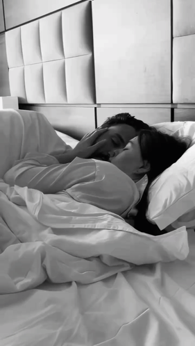 A Black And White Photo Of A Man And Woman Hugging GIF