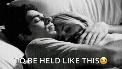 A Black And White Photo Of A Man And Woman Hugging With The Words To Be Held Like This Below Them GIF