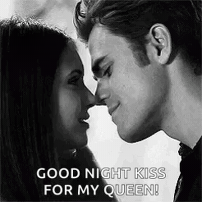 A Black And White Photo Of A Man And Woman Kissing Each Other . GIF