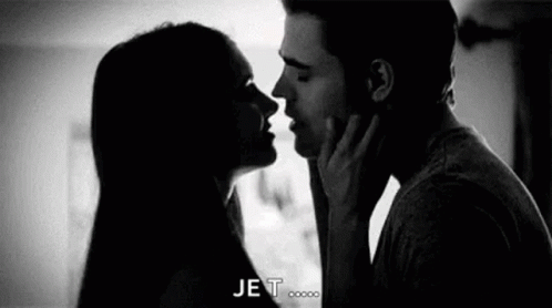 A Black And White Photo Of A Man And Woman Kissing Each Other . GIF