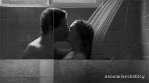 A Black And White Photo Of A Man And Woman Kissing GIF