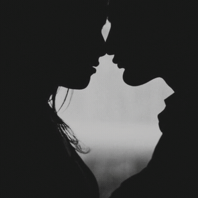 A Black And White Photo Of A Man And Woman Kissing With The Words " A Kiss Goodnight " Below Them GIF