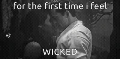 A Black And White Photo Of A Man And Woman Kissing With The Words For The First Time I Feel Wicked GIF