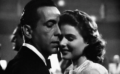 A Black And White Photo Of A Man And Woman Kissing . GIF