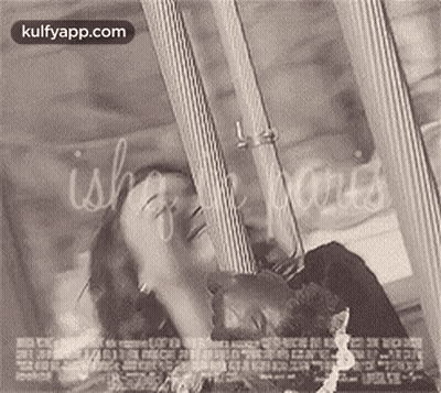A Black And White Photo Of A Man And Woman Laying Next To Each Other On A Bed . GIF