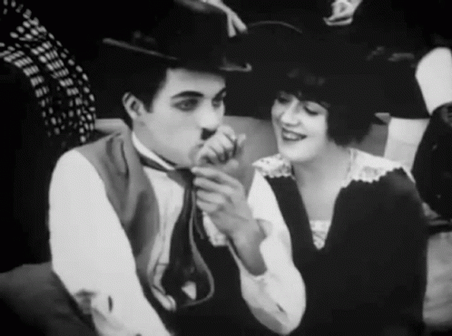 A Black And White Photo Of A Man And Woman GIF