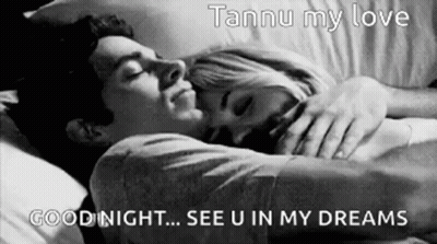 A Black And White Photo Of A Man And Woman Sleeping In Bed . GIF