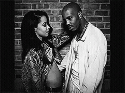 A Black And White Photo Of A Man And Woman Standing Next To Each Other . GIF
