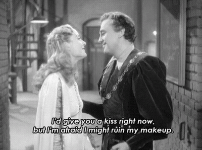 A Black And White Photo Of A Man And Woman With A Caption That Says " I 'D Give You A Kiss Right Now GIF