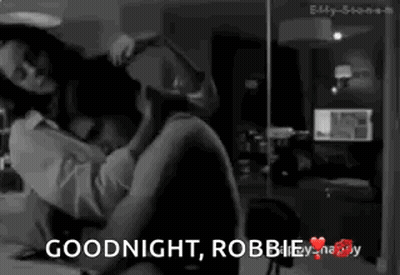 A Black And White Photo Of A Man And Woman With The Words Goodnight Robbie GIF