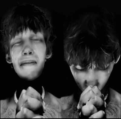 A Black And White Photo Of A Man Crying And Another Man Praying GIF