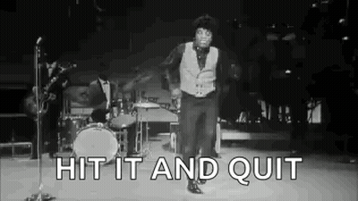 A Black And White Photo Of A Man Dancing On A Stage In Front Of A Microphone . GIF
