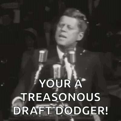 A Black And White Photo Of A Man Giving A Speech That Says Your A Treasonous Draft Dodger . GIF
