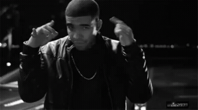 A Black And White Photo Of A Man Giving The Middle Finger While Standing In Front Of A Car . GIF