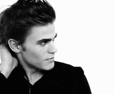 A Black And White Photo Of A Man Holding His Neck GIF