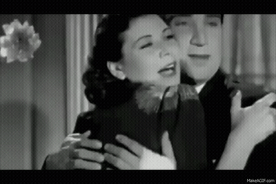 A Black And White Photo Of A Man Hugging A Woman . GIF