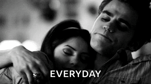 A Black And White Photo Of A Man Hugging A Woman With The Word Everyday Written Above Them GIF