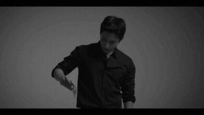 A Black And White Photo Of A Man In A Black Shirt And Black Pants . GIF