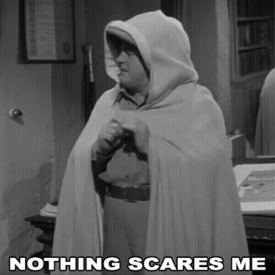A Black And White Photo Of A Man In A Cape With The Caption " Nothing Scares Me " GIF