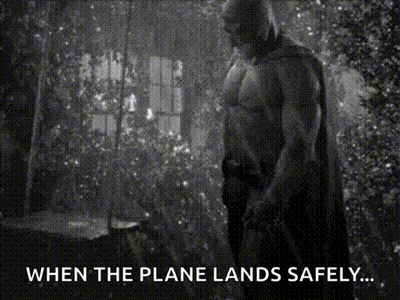 A Black And White Photo Of A Man In A Cape With The Caption " When The Plane Lands Safely ... " GIF