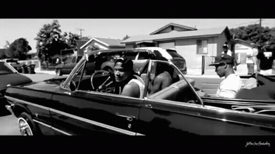 A Black And White Photo Of A Man In A Car With The Words Yellow On The Bottom Right GIF