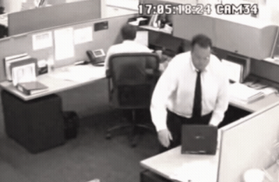 A Black And White Photo Of A Man In A Cubicle With Cam34 Written On The Bottom Right GIF