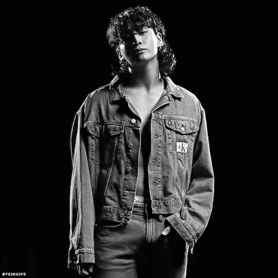 A Black And White Photo Of A Man In A Denim Jacket GIF