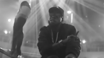 A Black And White Photo Of A Man In A Hat Giving A Thumbs Up GIF