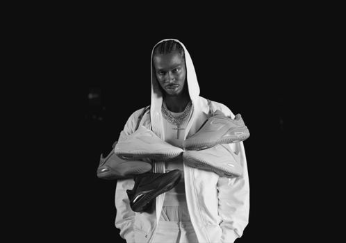 A Black And White Photo Of A Man In A Hooded Jacket GIF