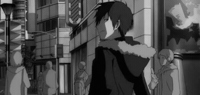 A Black And White Photo Of A Man In A Hoodie Walking Down A Street . GIF