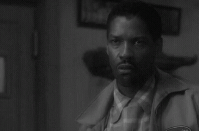 A Black And White Photo Of A Man In A Jacket GIF