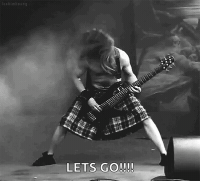 A Black And White Photo Of A Man In A Kilt Playing A Guitar With The Words Let 'S Go !!! Below Him GIF