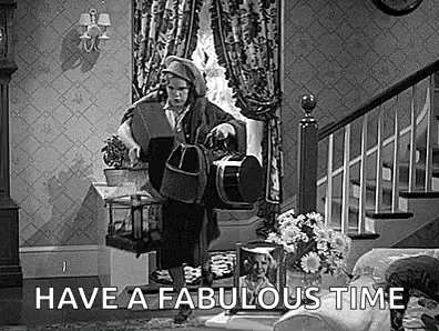 A Black And White Photo Of A Man In A Living Room With The Words `` Have A Fabulous Time '' Written On It . GIF