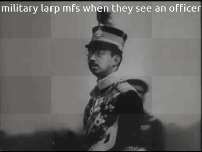 A Black And White Photo Of A Man In A Military Uniform GIF