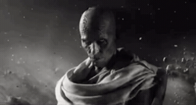 A Black And White Photo Of A Man In A Scarf . GIF