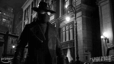 A Black And White Photo Of A Man In A Spider Noir Suit GIF