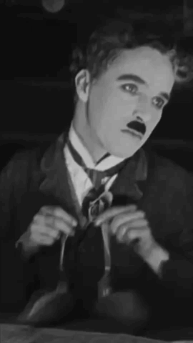 A Black And White Photo Of A Man In A Suit And Tie . GIF