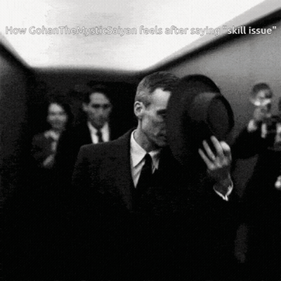 A Black And White Photo Of A Man In A Suit And Tie Holding His Hat GIF