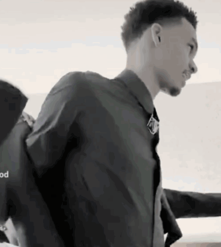 A Black And White Photo Of A Man In A Suit GIF