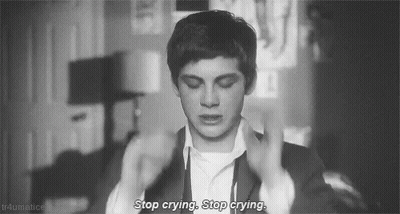 A Black And White Photo Of A Man In A Suit With The Words `` Stop Crying , Stop Crying '' Written On It . GIF