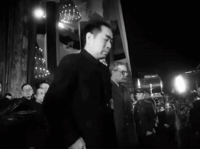 A Black And White Photo Of A Man In A Suit GIF