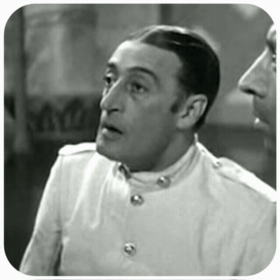 A Black And White Photo Of A Man In A White Jacket GIF