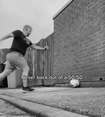 A Black And White Photo Of A Man Kicking A Soccer Ball With The Words Never Back Out Of A 50/50 Below Him GIF